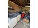 Utility area with washer and dryer, shelving, and assorted household items and tools at 501 S 98Th St, Mesa, AZ 85208