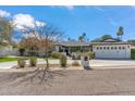 Charming one-story home with a well-manicured lawn, mature trees, and a double-door garage in a serene neighborhood at 5201 N 33Rd St, Phoenix, AZ 85018