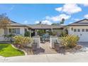 Inviting front entrance featuring a charming outdoor seating area, beautiful landscaping, and a welcoming front door at 5201 N 33Rd St, Phoenix, AZ 85018