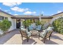 Cozy front porch with comfortable seating around a fire pit, lush greenery, and a welcoming entrance at 5201 N 33Rd St, Phoenix, AZ 85018