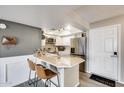 Well-lit kitchen featuring stainless steel appliances, an eat-in island with bar stools, and a convenient layout at 540 N May -- # 2151, Mesa, AZ 85201