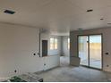 Interior view with drywall installed showing an open floor plan with sliding glass doors at 5893 N Nigal Rd, Casa Grande, AZ 85194