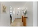 Bright entryway featuring wood floors, neutral paint, console table and artwork at 718 W Vine Ave, Mesa, AZ 85210