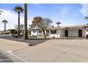 Beautiful one-story home featuring palm trees, neutral paint, rock landscaping and a wide driveway at 718 W Vine Ave, Mesa, AZ 85210