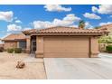 Charming single-story home featuring a desert landscape and a two-car garage at 7214 W Crest Ln, Glendale, AZ 85310