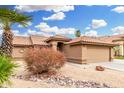 Charming single-story home with desert landscaping and a tiled roof at 7214 W Crest Ln, Glendale, AZ 85310