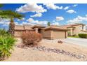 Charming single-story home with desert landscaping and a tiled roof at 7214 W Crest Ln, Glendale, AZ 85310