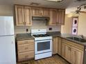 Well-equipped kitchen featuring light wood cabinetry, modern appliances, and a functional layout for cooking at 723 E Garnet Ave, Mesa, AZ 85204