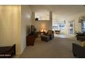 Bright living room with neutral tones, plush carpet, and open floor plan at 8199 E Sweet Acacia Dr, Gold Canyon, AZ 85118