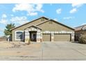 Charming single-story home featuring a three-car garage and low-maintenance desert landscaping at 906 E Beautiful Ln, Phoenix, AZ 85042