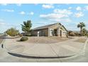 Spacious corner lot featuring a well-maintained yard with desert landscaping, mature trees, and green shrubs at 906 E Beautiful Ln, Phoenix, AZ 85042