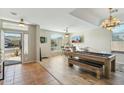 Bright and airy game room featuring a pool table, bar seating, and a view to the outside at 906 E Beautiful Ln, Phoenix, AZ 85042