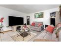 Comfortable living room showcasing tile flooring, neutral walls, and cozy seating at 917 N Nina Dr, Mesa, AZ 85201