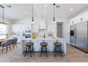 Bright, open kitchen featuring a large island with bar seating and stainless steel appliances at 9362 E Cloudview Ave, Gold Canyon, AZ 85118