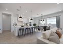 Modern kitchen and dining area with stainless appliances, island seating, and lots of natural light at 9398 E Cloudview Ave, Gold Canyon, AZ 85118