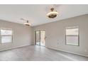 Bright living room featuring sliding glass door and neutral wall color at 9621 N 82Nd Ln, Peoria, AZ 85345