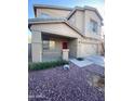 Two-story home featuring a covered porch, an attached two-car garage, and a combination of stucco and siding at 11821 W Yuma St, Avondale, AZ 85323