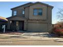 Two-story home featuring a covered porch, an attached two-car garage, and a combination of stucco and siding at 11821 W Yuma St, Avondale, AZ 85323