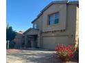 Two-story home featuring a covered porch, an attached two-car garage, and a combination of stucco and siding at 11821 W Yuma St, Avondale, AZ 85323