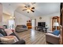 Comfortable living room with stylish flooring, neutral walls, and a cozy atmosphere at 12766 W Dreyfus Dr, El Mirage, AZ 85335