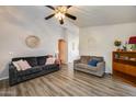 Inviting living room featuring modern decor, stylish sofas, hardwood floors, and ample space at 12766 W Dreyfus Dr, El Mirage, AZ 85335