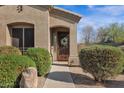 A charming home entrance with a decorative door, a wreath, and well-maintained landscaping at 13121 S 178Th Ave, Goodyear, AZ 85338