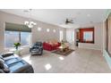 Bright and spacious living room with tile flooring, neutral walls, and lots of natural light at 13121 S 178Th Ave, Goodyear, AZ 85338