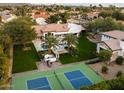 Expansive aerial view of the estate showcasing a tennis court, pool, spa, outdoor lounge, and lush landscaping at 13670 N 85Th Pl, Scottsdale, AZ 85260