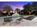 Inviting pool with a water feature, lounge chairs, and palm trees, perfect for relaxation and outdoor enjoyment at 13670 N 85Th Pl, Scottsdale, AZ 85260