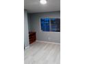 Bedroom featuring new laminate flooring and a window for natural light at 1402 S 76Th Pl, Mesa, AZ 85209