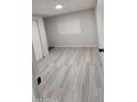 Bright bedroom with gray flooring, a window and a door, offering a modern look at 1402 S 76Th Pl, Mesa, AZ 85209