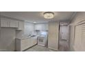 Bright kitchen with white cabinets and modern appliances offers a clean look at 1402 S 76Th Pl, Mesa, AZ 85209