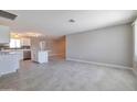 Open-concept living space with tile flooring and a view into the kitchen at 15032 N 24Th N Pl, Phoenix, AZ 85032