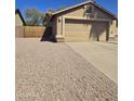 View of the home's two-car garage and driveway at 1688 E Krystal St, Casa Grande, AZ 85122