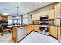 Well-lit kitchen featuring stainless steel appliances and ample counter space for culinary adventures at 17200 W Bell Rd # 357, Surprise, AZ 85374