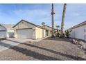 Charming home featuring desert landscaping, palm trees, and a two-car garage at 1780 E Countrywalk Ln, Chandler, AZ 85225