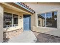 Inviting home entrance with blue door, dual pane windows and desert landscaping at 1780 E Countrywalk Ln, Chandler, AZ 85225