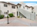 Exterior shot of condo with neutral stucco, landscaped ground cover and walkway to entry at 1825 W Ray Rd # 1148, Chandler, AZ 85224