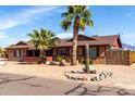 Inviting single-story home featuring desert landscaping, mature palm trees, and cactus accents at 2031 S Cactus Rd, Apache Junction, AZ 85119