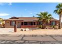 Inviting single-story home featuring a brick-accented porch and desert-style landscaping for low maintenance at 2031 S Cactus Rd, Apache Junction, AZ 85119