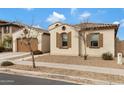 Charming single-story home featuring a two-car garage, desert landscaping, and neutral color palette at 22854 E Sonoqui Blvd, Queen Creek, AZ 85142