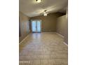 Spacious living room featuring tile flooring and access to the patio at 2634 N Saffron Cir, Mesa, AZ 85215