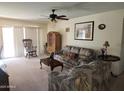 Comfortable living room with natural light, a ceiling fan, and access to the outdoor space at 2839 W Villa Maria Dr, Phoenix, AZ 85053