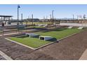 Community outdoor area features a cornhole game and benches for residents' enjoyment at 37326 W San Clemente St, Maricopa, AZ 85138