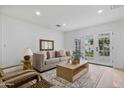 Comfortable living room with neutral tones, large windows, and access to the backyard at 4131 E Minnezona Ave, Phoenix, AZ 85018