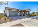 Single-story home with a two-car garage and desert landscaping with covered front porch at 4330 S Neutron --, Mesa, AZ 85212