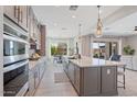 Bright, open kitchen with stainless steel appliances, an island, and plenty of natural light at 4330 S Neutron --, Mesa, AZ 85212
