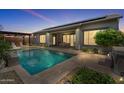 An inviting backyard pool with a pergola, lounge chairs, and a neatly paved patio at 4330 S Neutron --, Mesa, AZ 85212