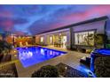 Inviting pool with a spa, covered patio, and lush landscaping, perfect for relaxing evenings at 4330 S Neutron --, Mesa, AZ 85212