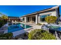 A view of a sparkling swimming pool with spa, patio seating and mature landscaping at 4330 S Neutron --, Mesa, AZ 85212